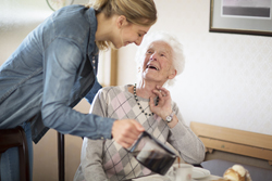 Frau schenkt alter Dame Kaffee ein