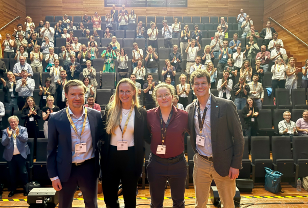 Die Teilnehmenden des ersten DGG-Science-Slams lassen sich auf der Bühne feiern (v.l.): Dr. Bendix Labeit, Rebecca Scheck, Birte Gohde und Dr. Johannes Trabert. 